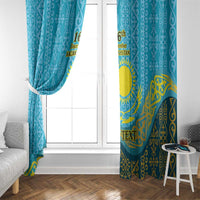 Blue and gold curtain panels with emblem motif near window glass
