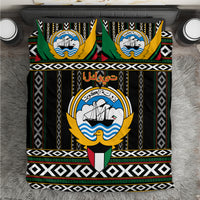 Black bedding set with green, gold, red emblem and geometric striped borders