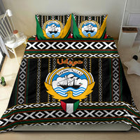 Black bedding set with emblem panel, green and gold accents, and bold patterned stripes