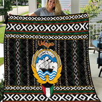 Personalized black quilt with central emblem and white, green, red geometric borders