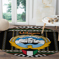 Round black carpet with large ship-and-waves emblem and Arabic script on center panel