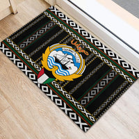 Black rubber doormat with central emblem and repeating diamond pattern edges