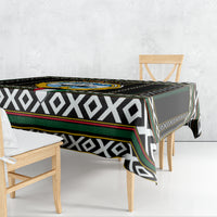 Black tablecloth with diamond patterns and multi-color trim over dining table