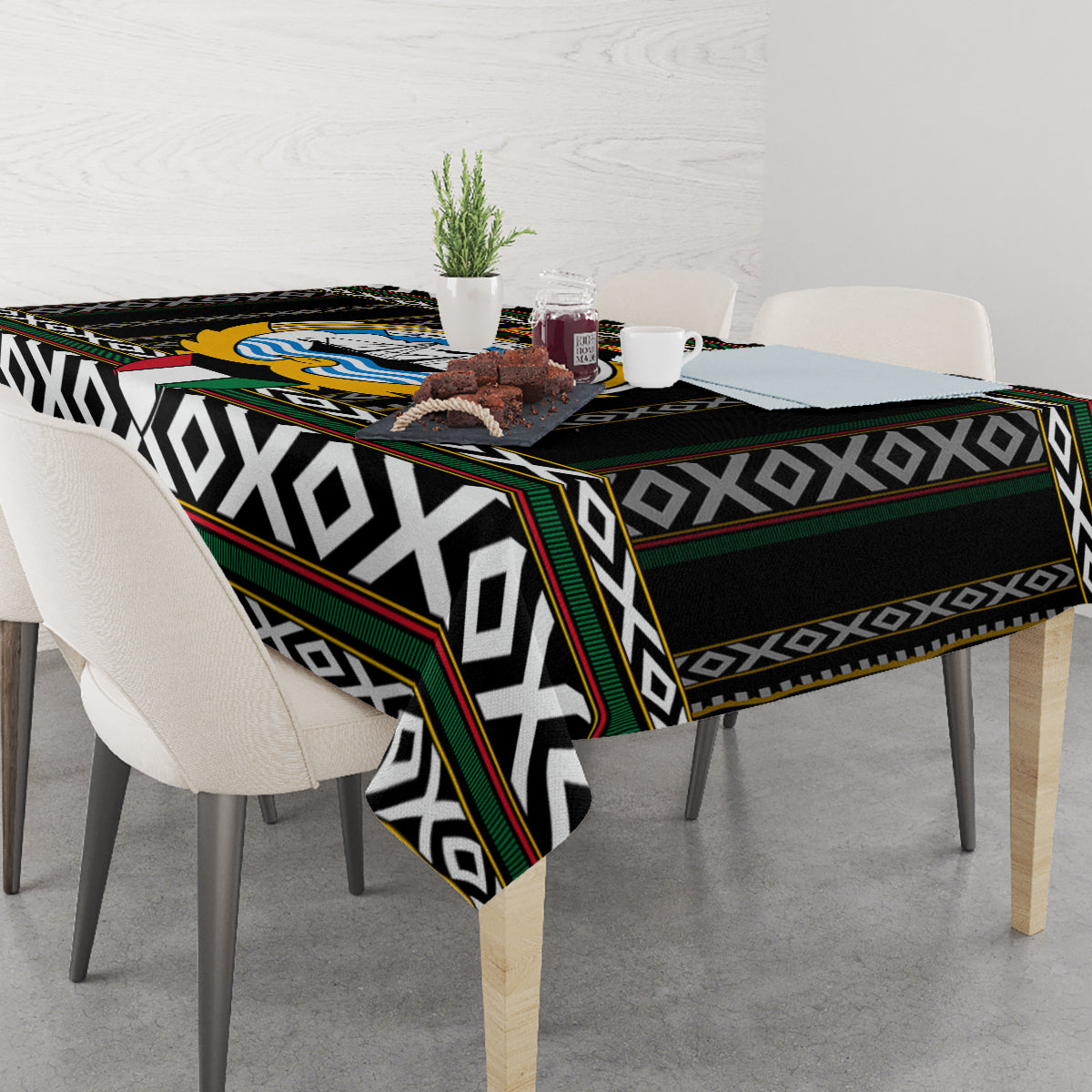 Black tablecloth with bold geometric stripes, diamond motifs, and multi-color edging