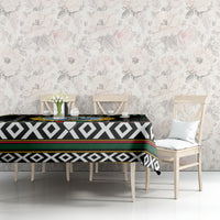 Black tablecloth with diamond stripe pattern and hawk-style crest on tabletop