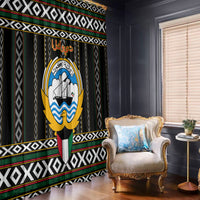Black window curtain panels with patterned border and large hawk-style emblem print.