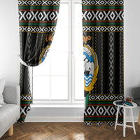 Black window curtain with top heading and bold border; circular hawk-style emblem visible.