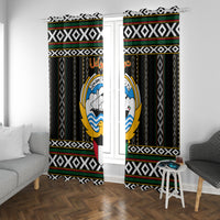 Black window curtain pair with vertical patterned stripes and circular emblem in each panel.