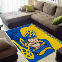 Blue and gold folk pattern area rug with clasped hands graphic and decorative border