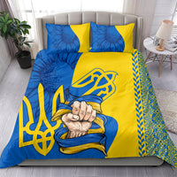 Blue and yellow bedding set with two matching pillows, trident emblem, and floral folk prints