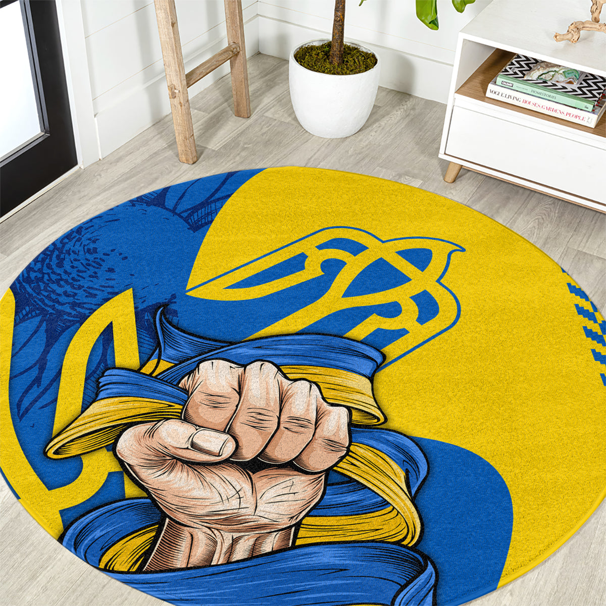 Round area rug with yellow and blue clenched fist and trident emblem print