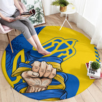Round printed area rug, yellow and blue with clenched fist and trident emblem