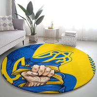 Round yellow and blue area rug with clenched fist and trident emblem design