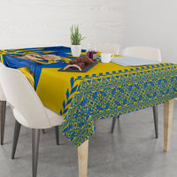 Tablecloth with gold base, blue swirls, and green ornamental edge pattern