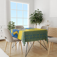 Tablecloth with blue and gold folk design, ornate stripe trim, and drop-edge