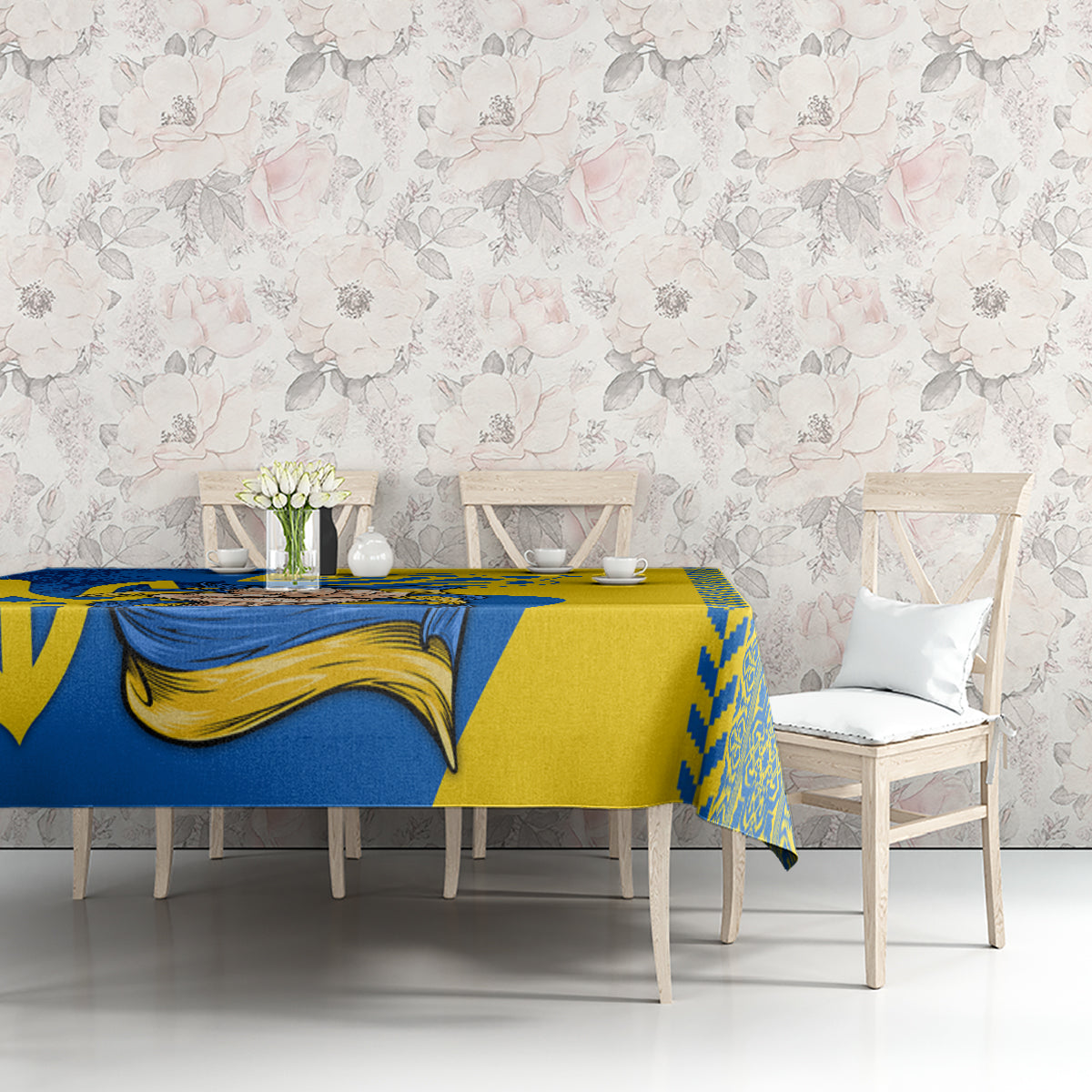 Square tablecloth with blue-and-gold folk pattern across tabletop and matching border
