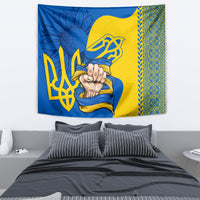 Blue and gold Ukrainian folk tapestry with trident emblem hanging above bed
