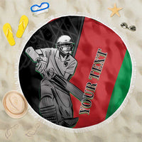Round beach blanket with fringe, cricket player graphic on red, green, and black
