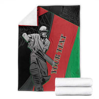 Afghanistan cricket blanket folded with cricket player artwork and black-red-green colors