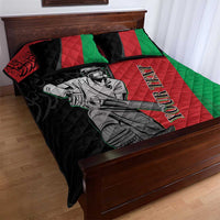 Quilt bed set featuring cricket player art on black, red, and green quilt with two pillows