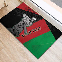 Cricket rubber doormat on light wood floor, black red green player illustration with custom text