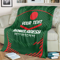 Green Bangladesh cricket blanket on cream sofa, red emblem and custom text.