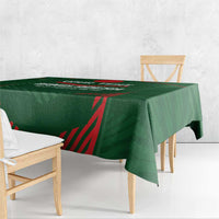 Green cricket tablecloth draped over table edge with red angular sports graphic