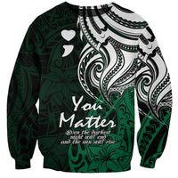 Unisex crewneck sweatshirt in dark green with white tribal print and heart, front view.