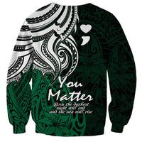 Unisex crewneck sweatshirt in dark green with large white-and-black tribal design and You Matter text.