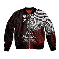 Red bomber jacket with black trim, white tribal print, hearts, and front zipper