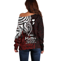 Women’s off-shoulder sweater, back view, dark base with white tribal heart graphic