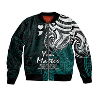 Unisex bomber jacket with turquoise tribal print, black sleeves, heart motifs, ribbed hem