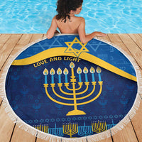 Blue round Hanukkah beach blanket with yellow menorah, Star of David, and fringe edge