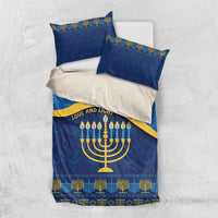Blue Hanukkah bedding set laid flat: duvet and two pillowcases with menorah and gold pattern
