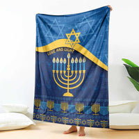 Blue Hanukkah blanket featuring a gold Star of David, menorah candles, 'Love and Light' text
