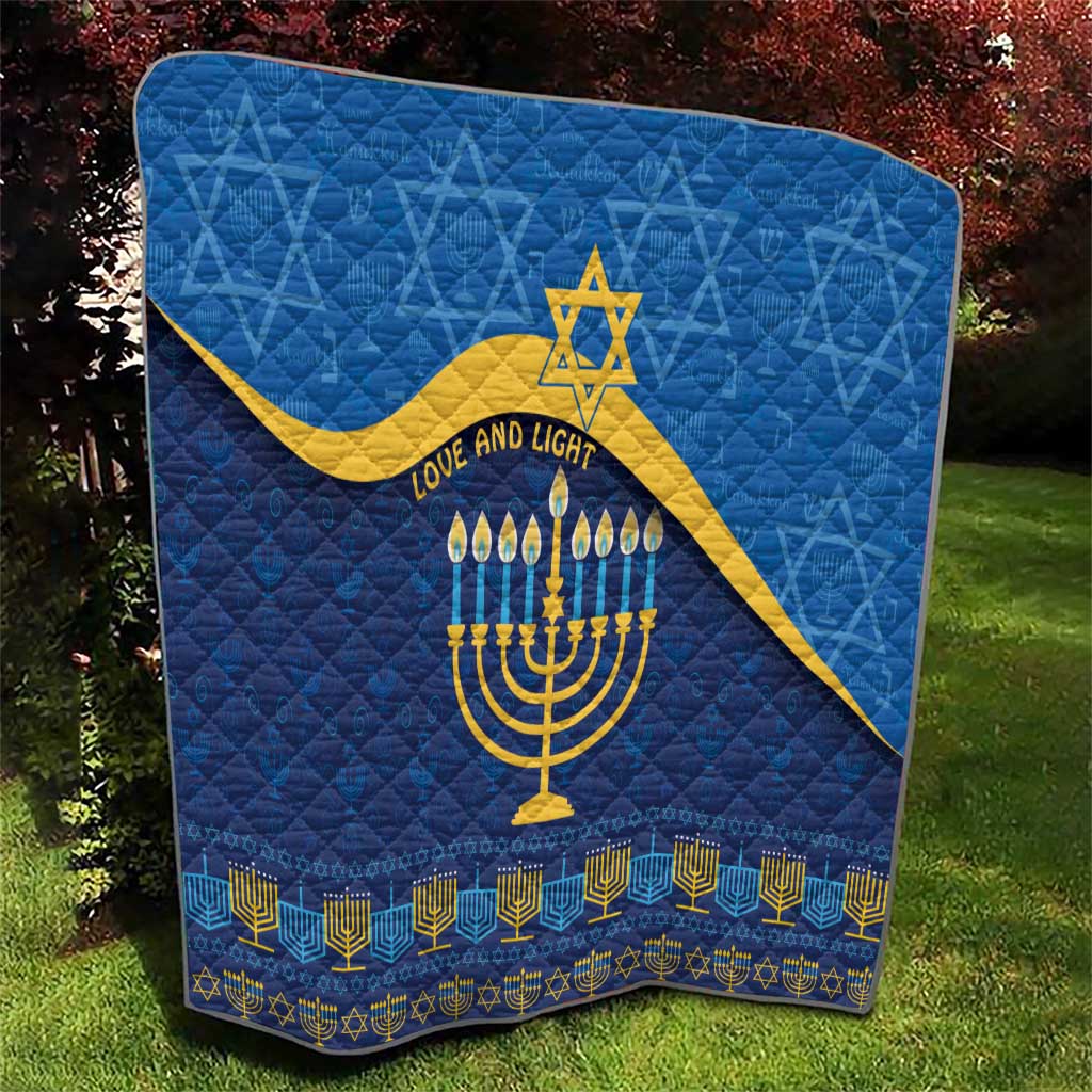 Blue Hanukkah quilt with quilted texture, yellow Star of David, menorah, and candle motifs