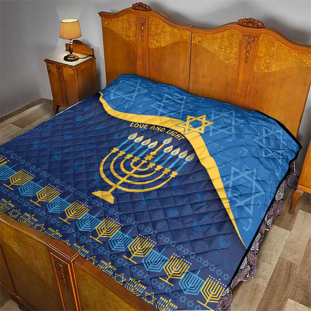 Blue Hanukkah quilt on bed showing yellow Star of David and menorah with 'LOVE AND LIGHT'