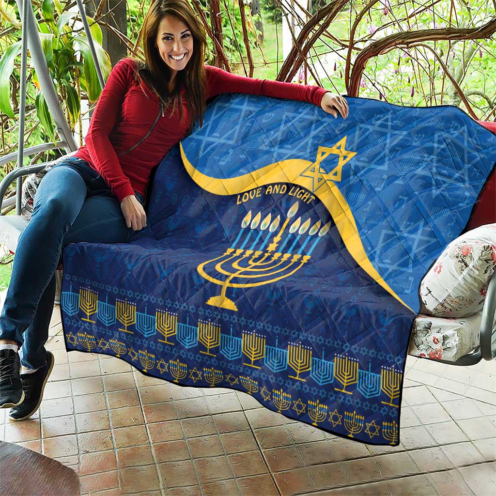 Blue Hanukkah quilt with yellow Star of David, menorah candles, and decorative border
