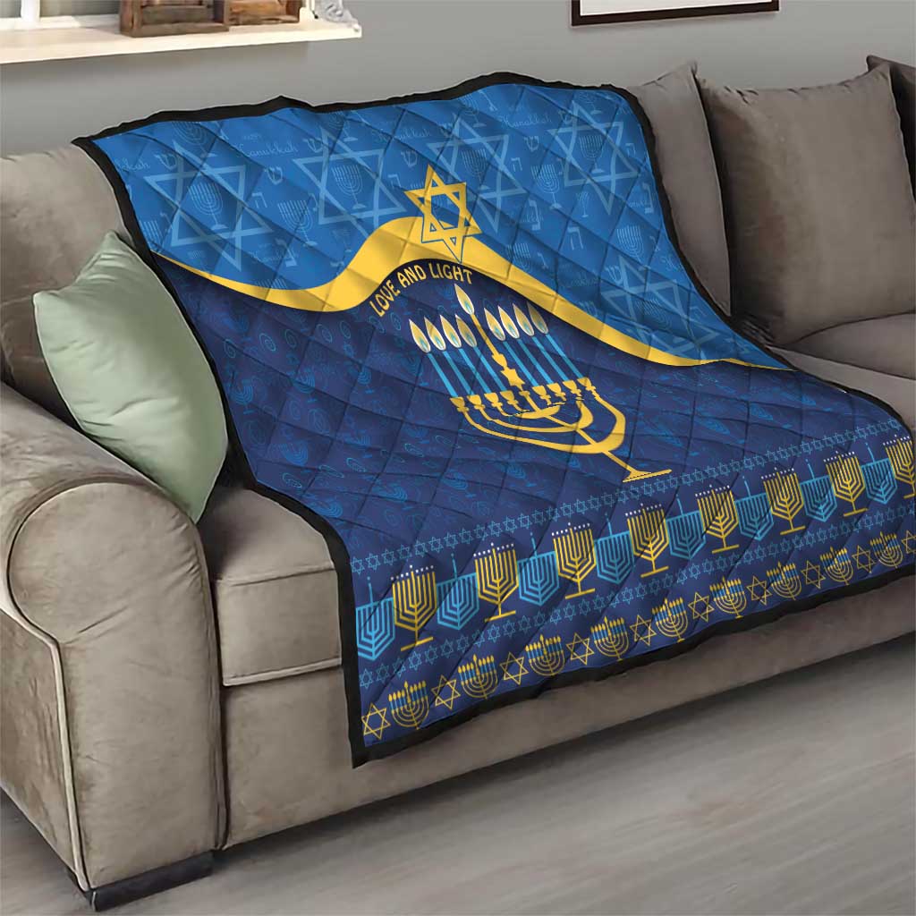 Blue Hanukkah quilt on sofa with yellow Star of David, menorah, and menorah-pattern border