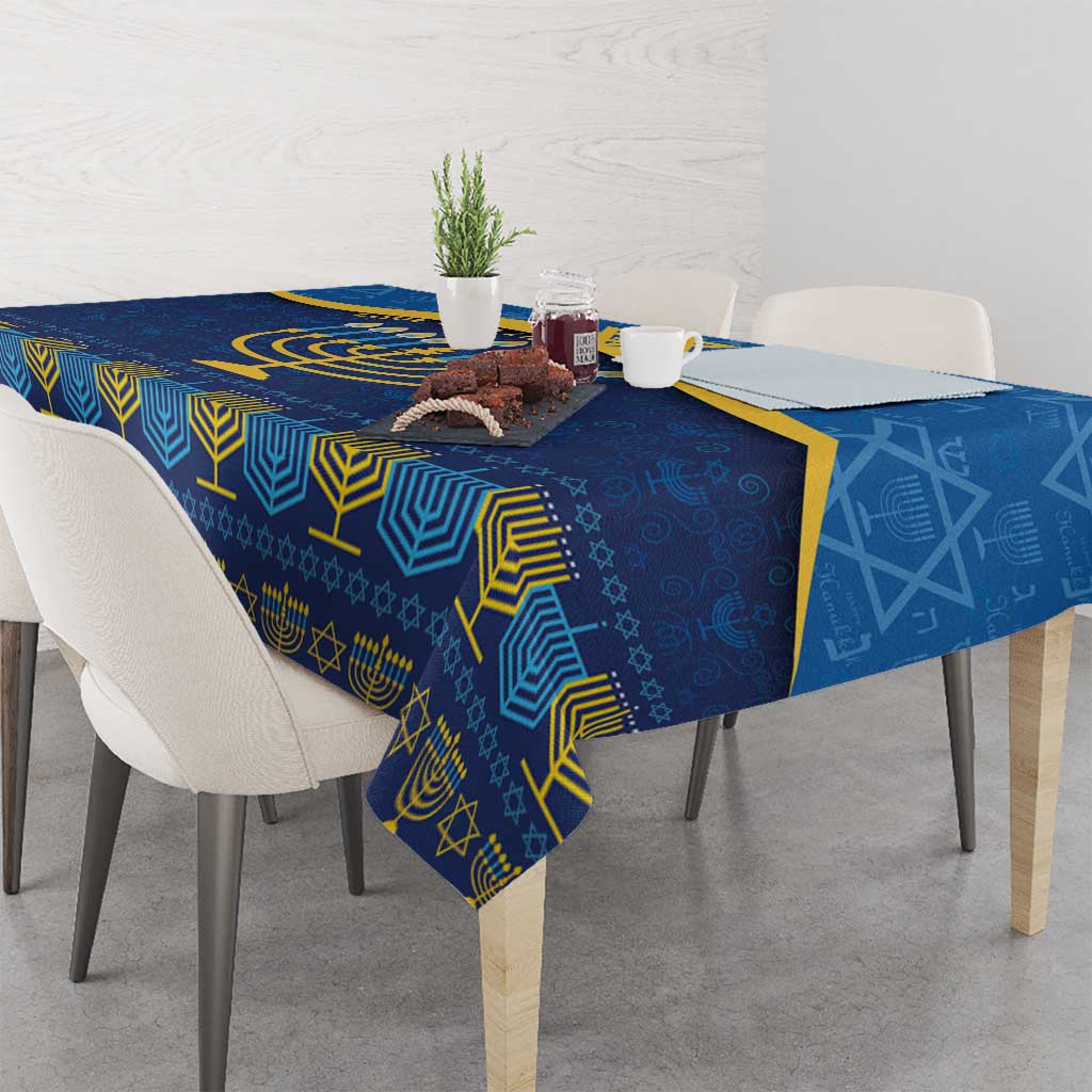 Blue Hanukkah tablecloth on a dining table, featuring gold menorah and star accents