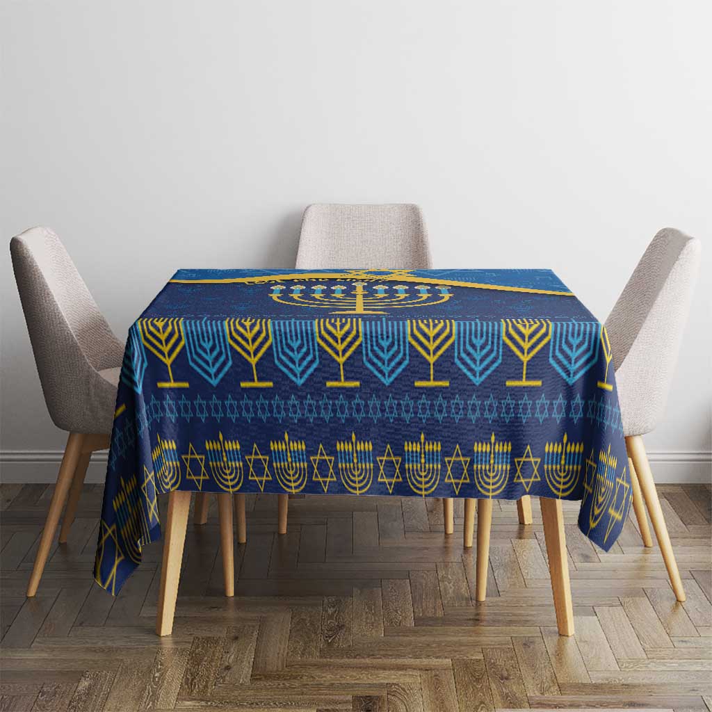 Blue Hanukkah tablecloth centered on a table with gold menorah and geometric symbols