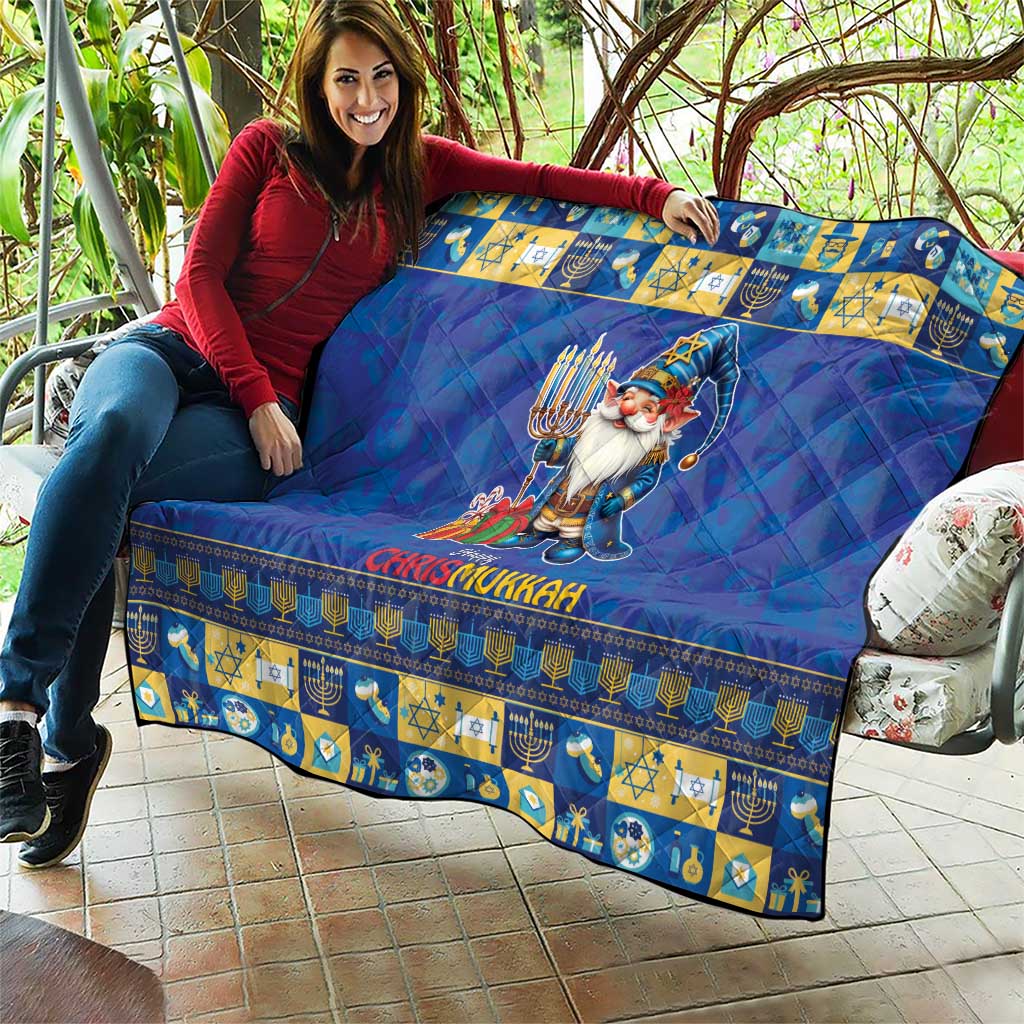 Blue quilt draped over couch with gnome holding menorah, “Happy Chrismukkah” lettering
