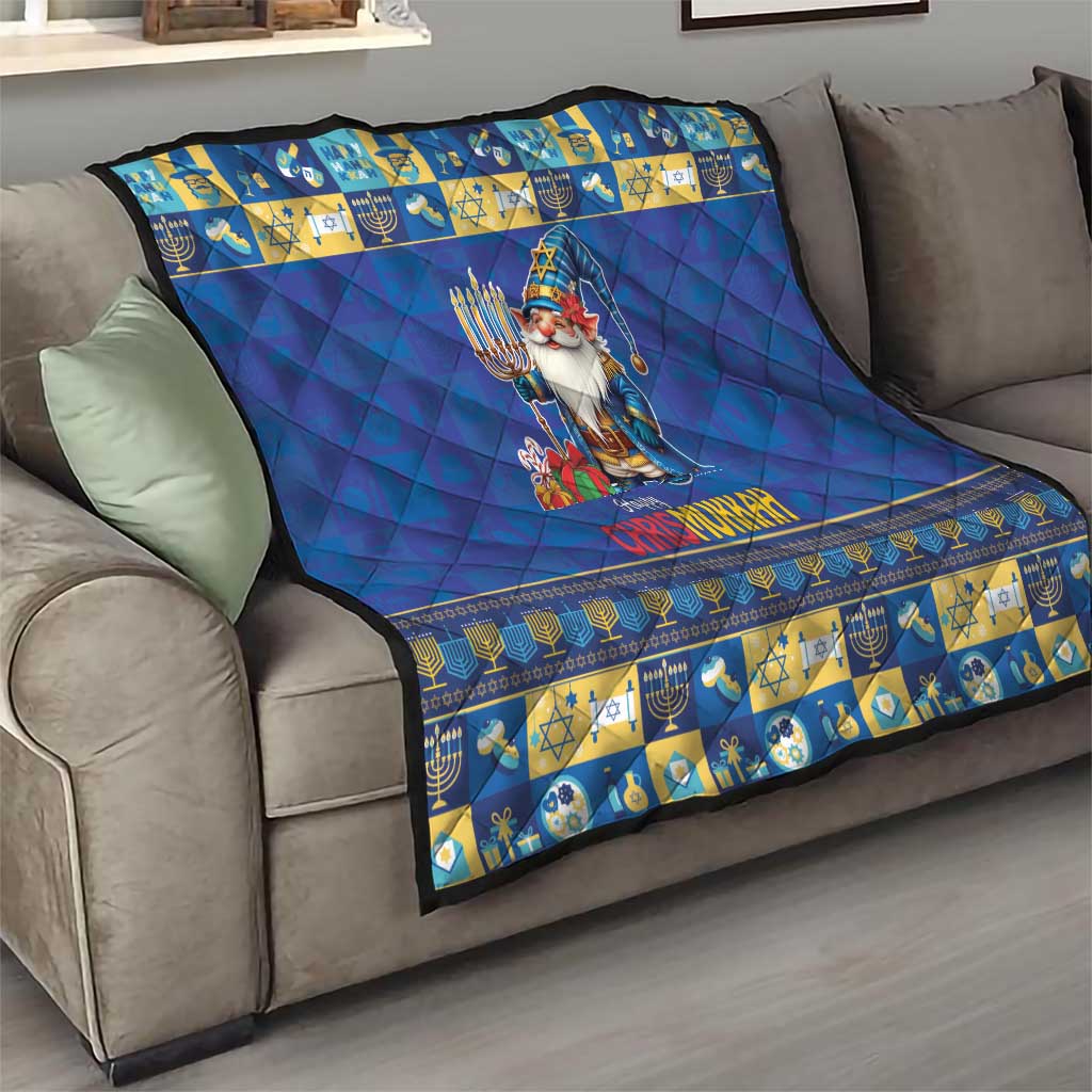 Blue quilt on sofa with gnome holding a menorah, blue diamond quilting, and patterned strip