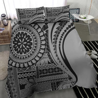 Black and white patterned bedding set with large circular emblem on duvet