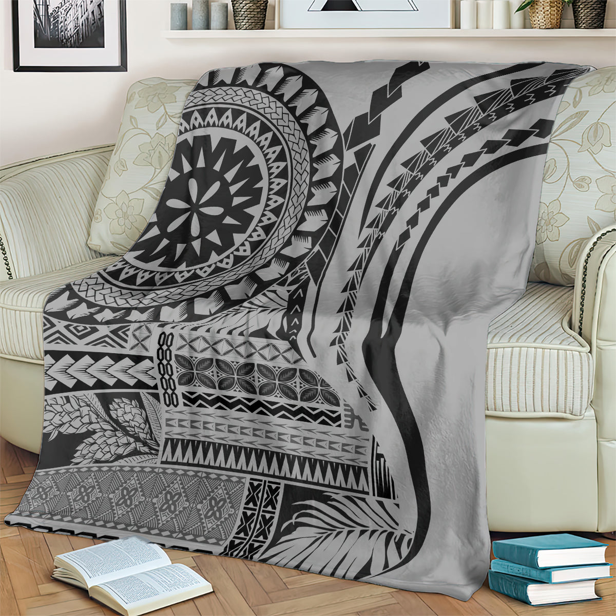 Black siapo art throw blanket draped over a couch, featuring circular mandala and stripes