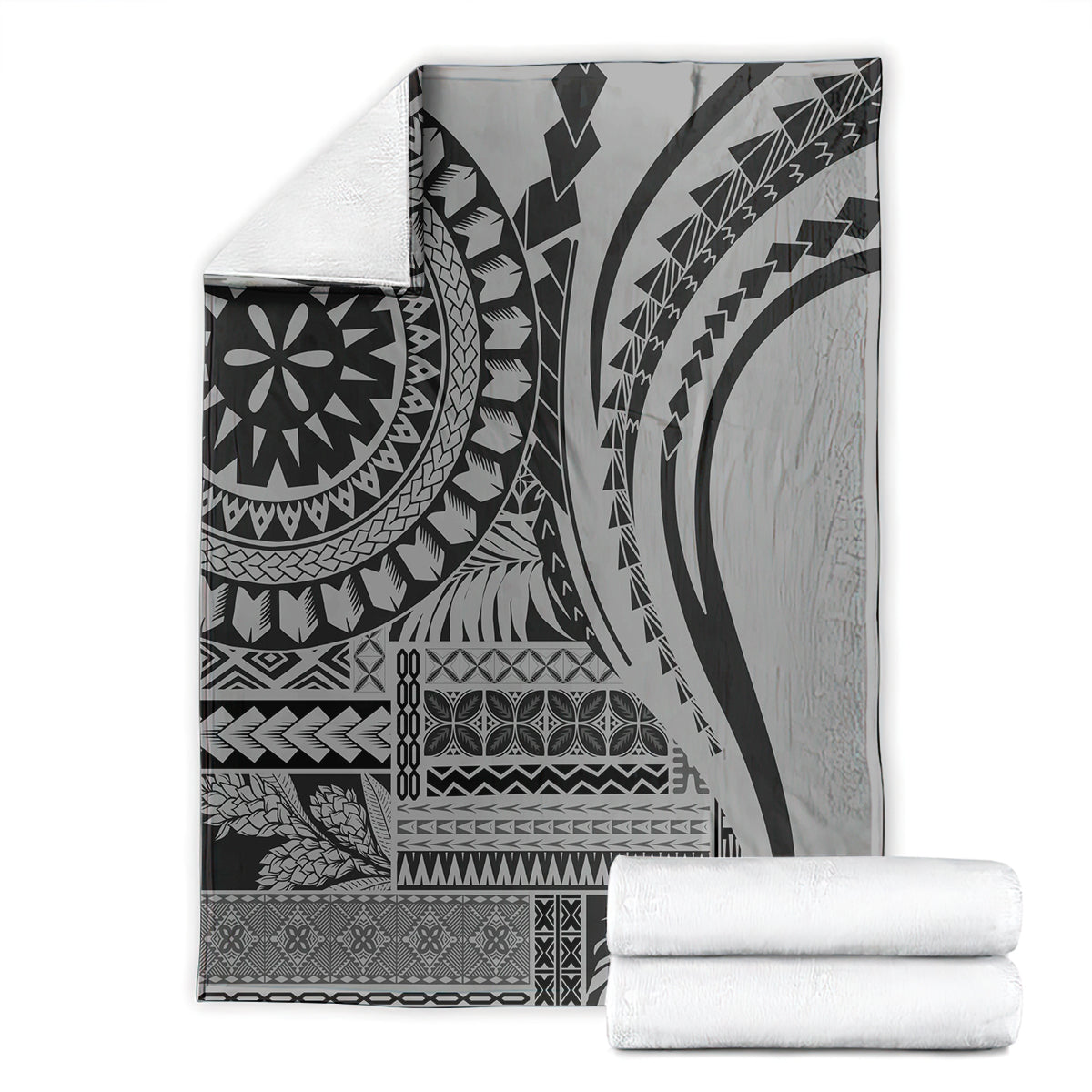 Black siapo art throw blanket neatly folded, with tribal geometric and mandala designs