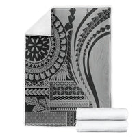 Black siapo art throw blanket neatly folded, with tribal geometric and mandala designs