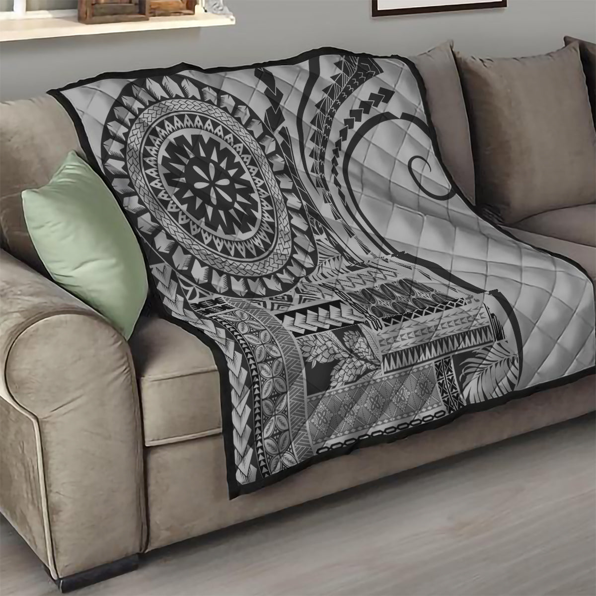 Black and white geometric quilt with mandala medallion and crescent moon on couch