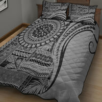 Black and white quilt with circular tribal print and diagonal stripe design, quilted texture