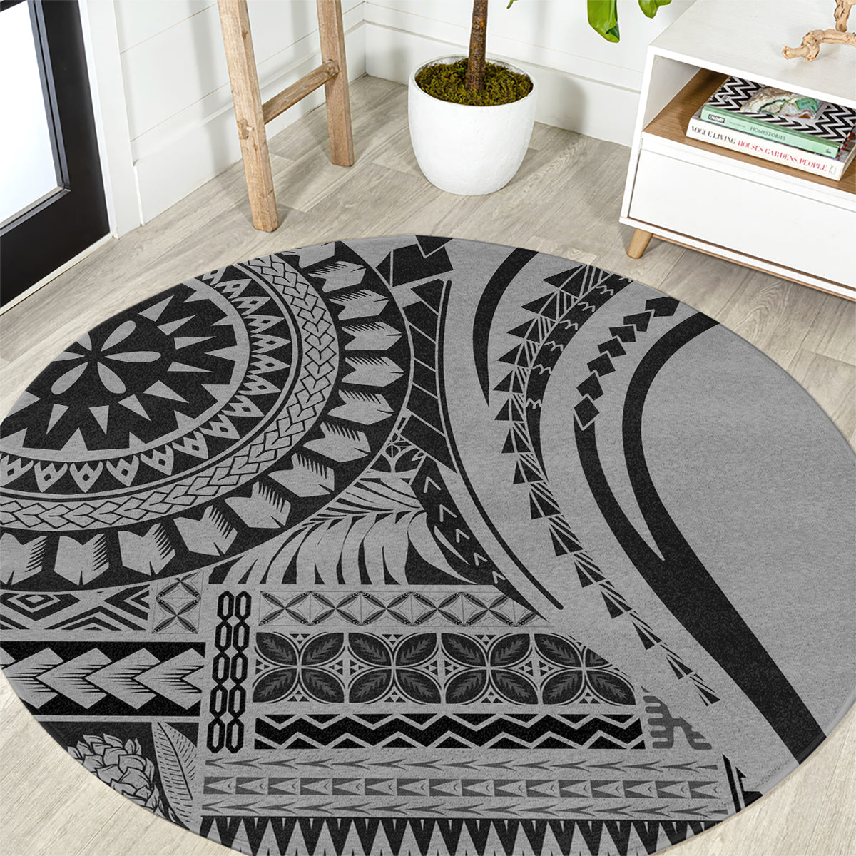 Round black tribal patterned area rug with circular motif